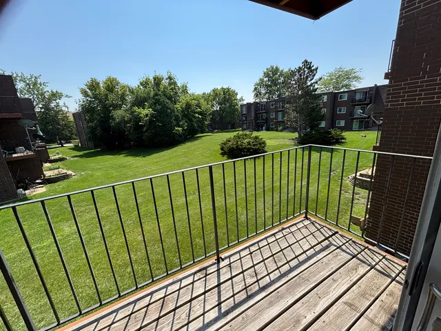 a view of balcony with wooden floor and fence