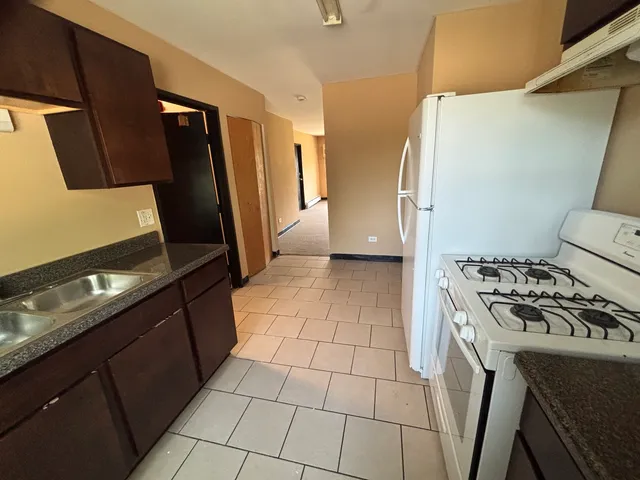 a kitchen with a stove a refrigerator and a counter top