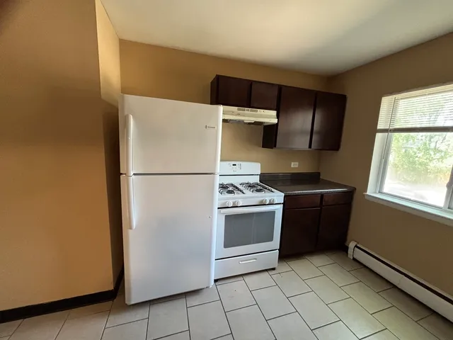a kitchen with a refrigerator and a stove