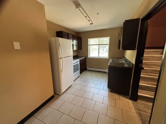 a kitchen with a refrigerator and a stove