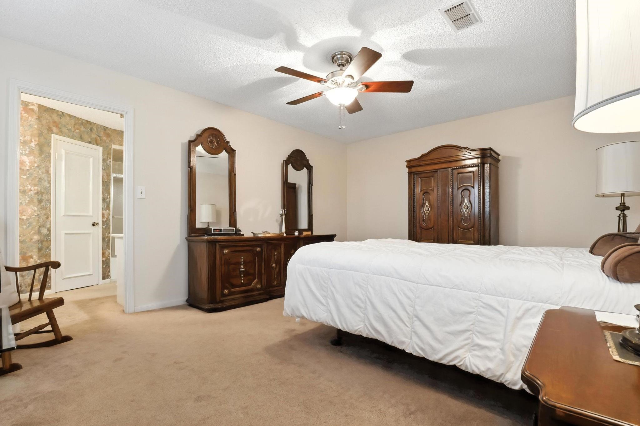2910 Riata Lane Houston, TX 77080 - Photo 13 of 23 a bedroom with a bed and ceiling fan