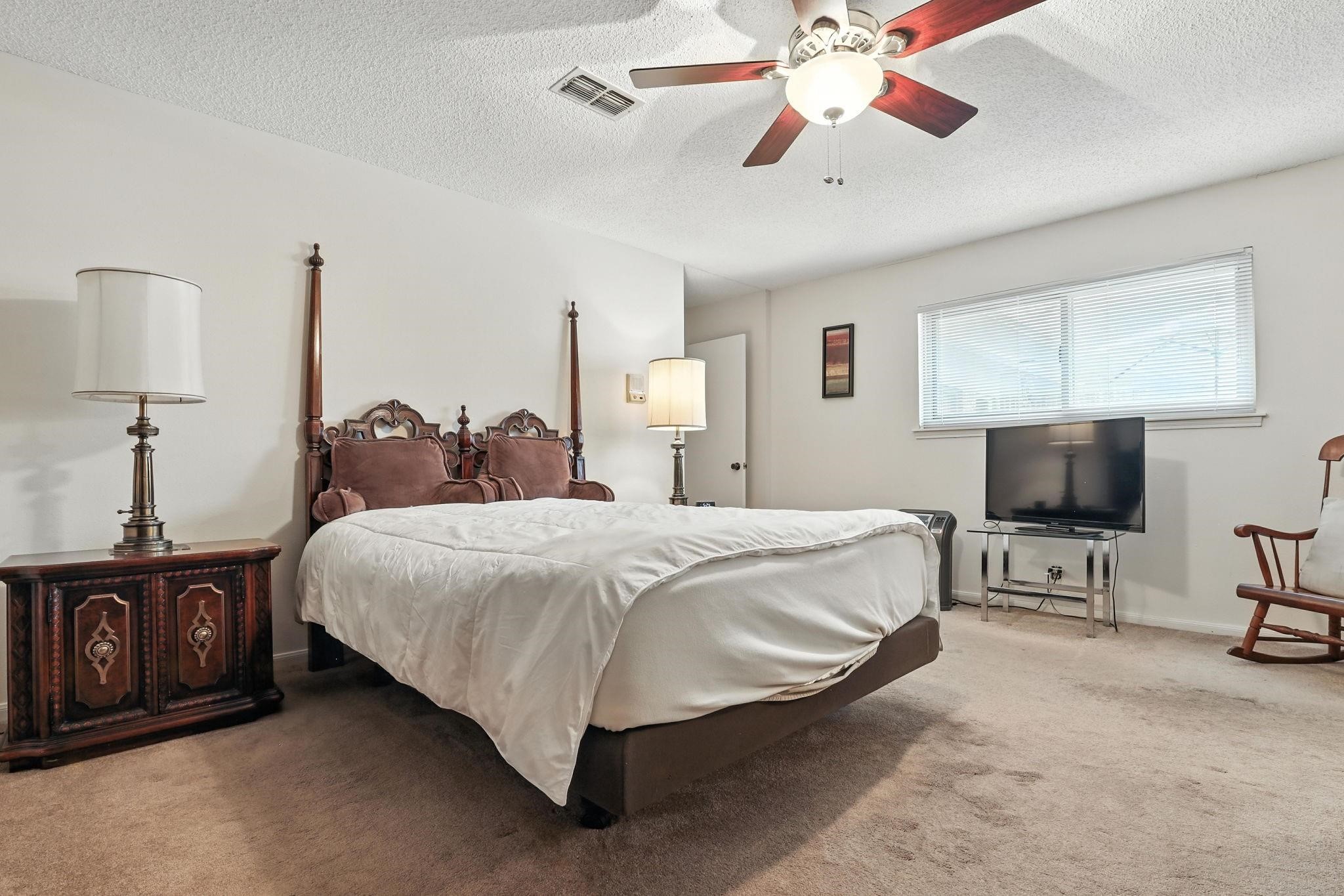 2910 Riata Lane Houston, TX 77080 - Photo 15 of 23 a bedroom with a bed and a flat screen tv
