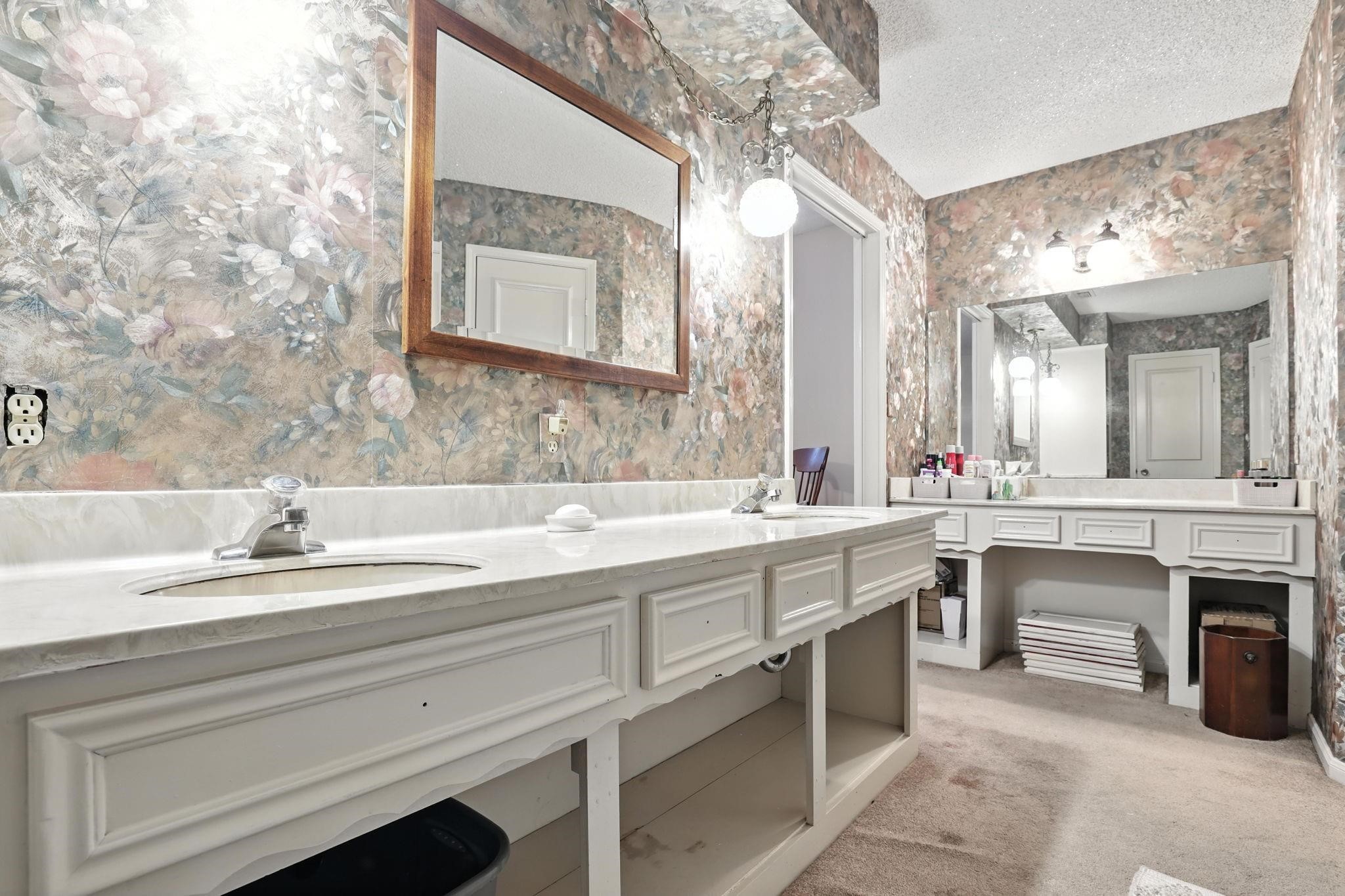 2910 Riata Lane Houston, TX 77080 - Photo 16 of 23 a spacious bathroom with a sink double vanity and a mirror