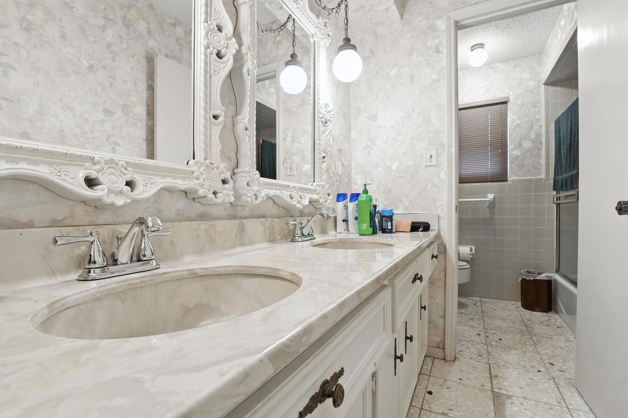 2910 Riata Lane Houston, TX 77080 - Photo 19 of 23 a bathroom with a sink and a mirror