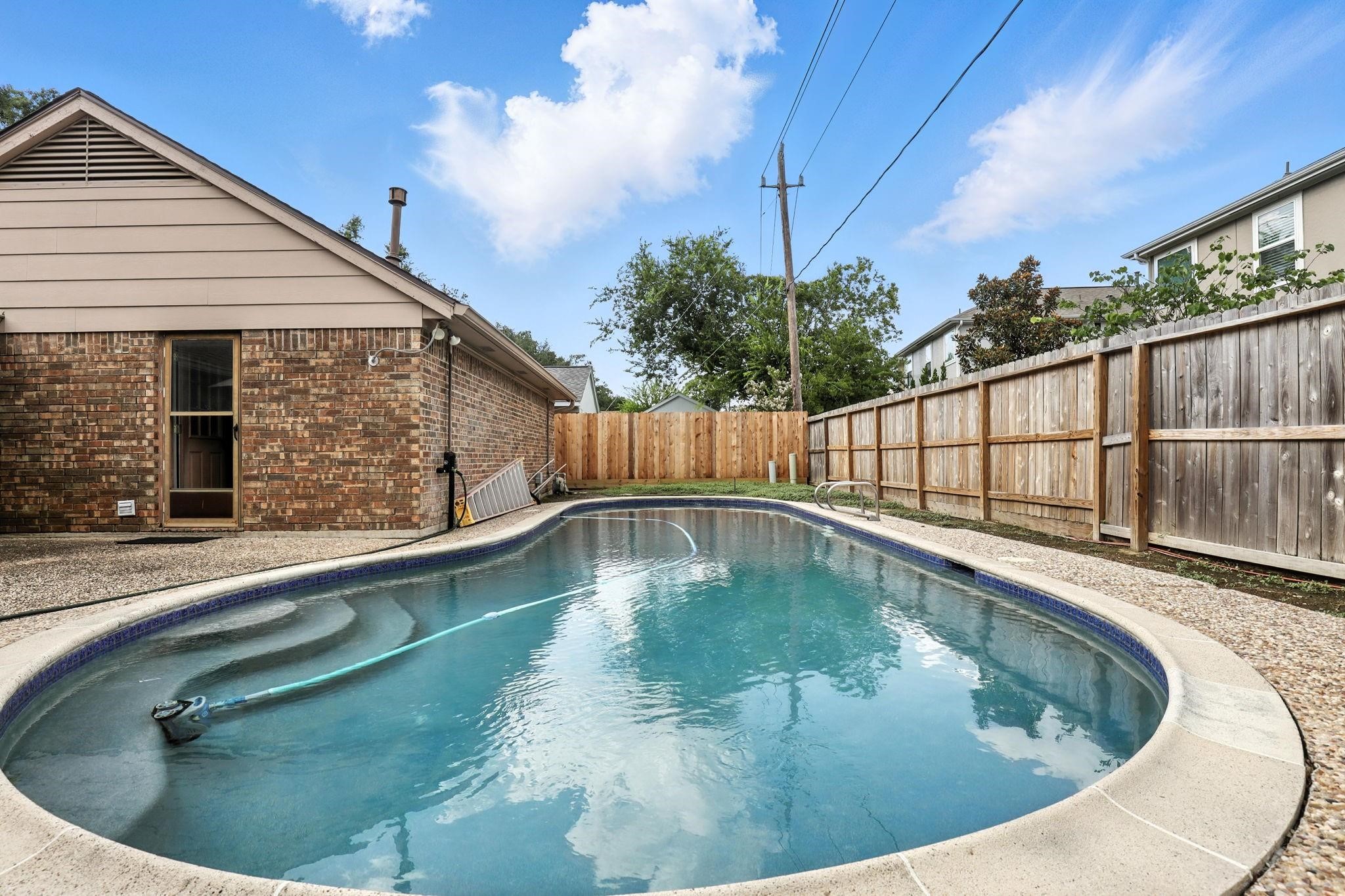2910 Riata Lane Houston, TX 77080 - Photo 20 of 23 a view of a swimming pool with a patio