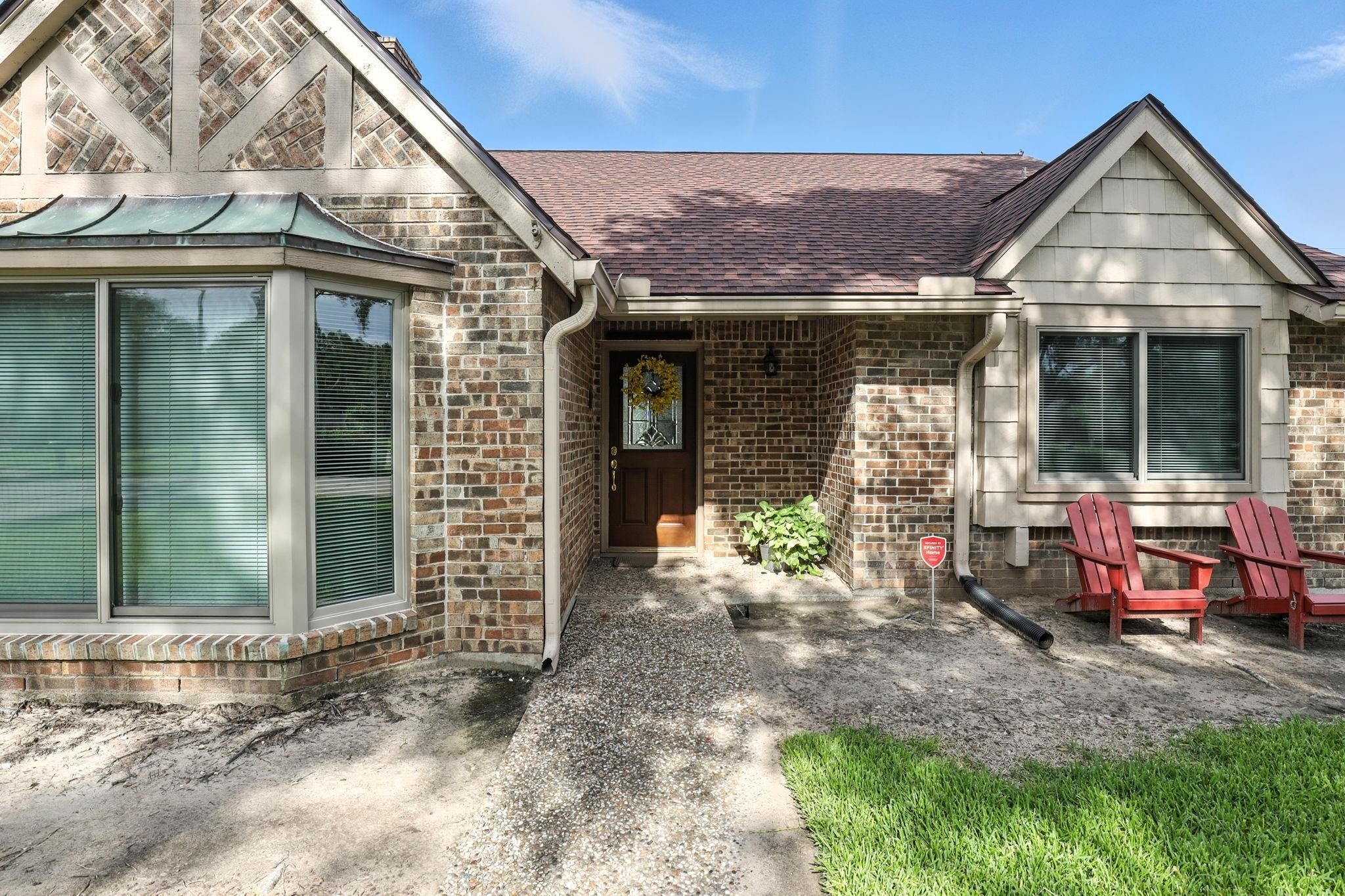 2910 Riata Lane Houston, TX 77080 - Photo 3 of 23 a view of a house that has a lots of windows and plants