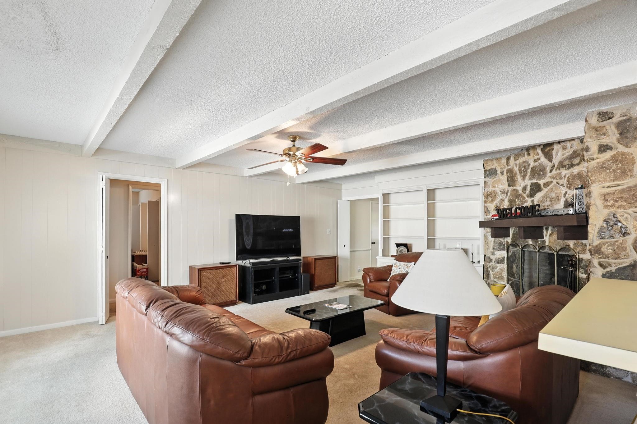 2910 Riata Lane Houston, TX 77080 - Photo 7 of 23 a living room with furniture a flat screen tv and a fireplace