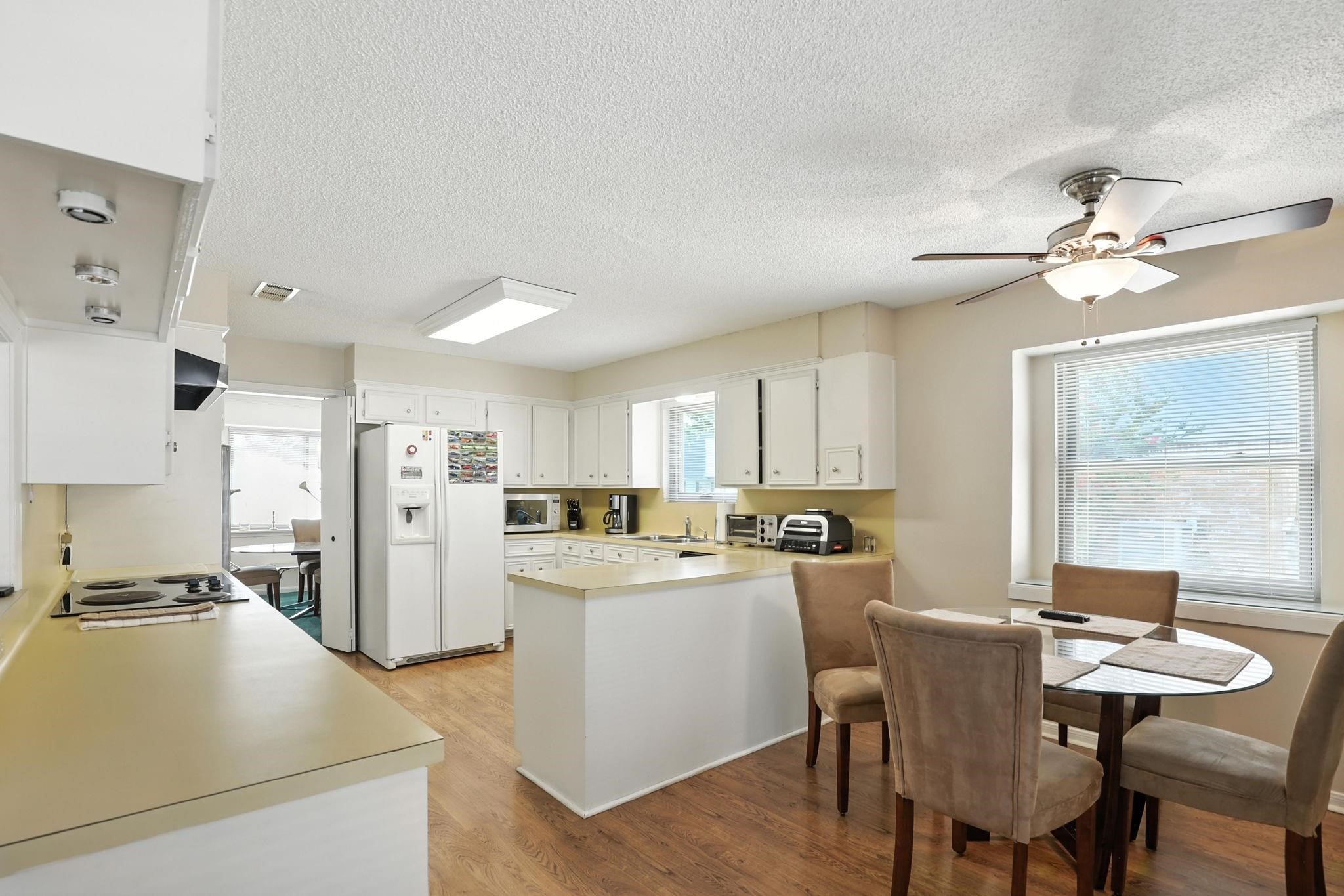 2910 Riata Lane Houston, TX 77080 - Photo 8 of 23 a kitchen with refrigerator cabinets and dining table