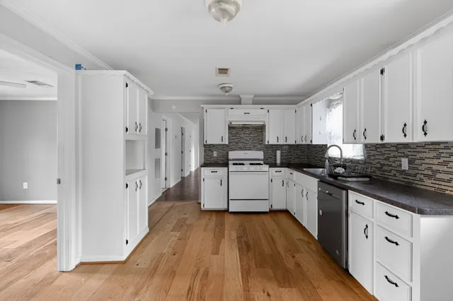a kitchen with stainless steel appliances a white cabinets and sink