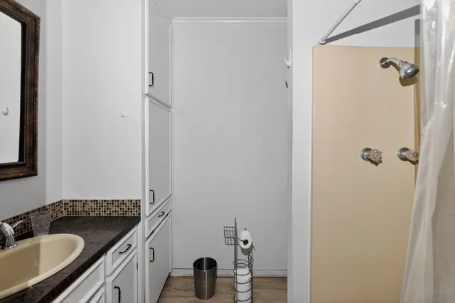a bathroom with a granite countertop sink and a mirror