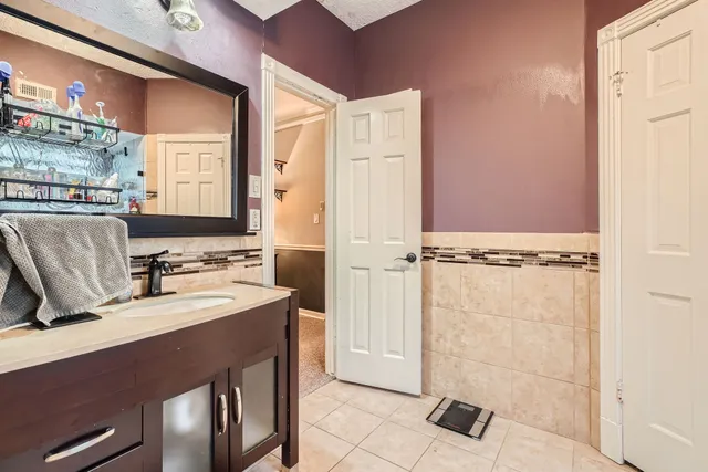 a bathroom with a sink a mirror and a shower