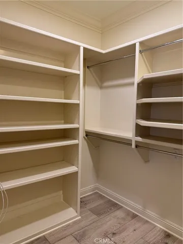 a view of walk in closet with empty racks