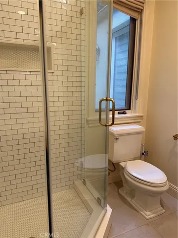 a white toilet sitting next to a bathroom sink
