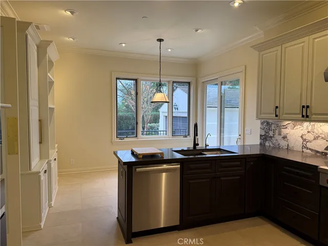 a kitchen with granite countertop a sink and cabinets
