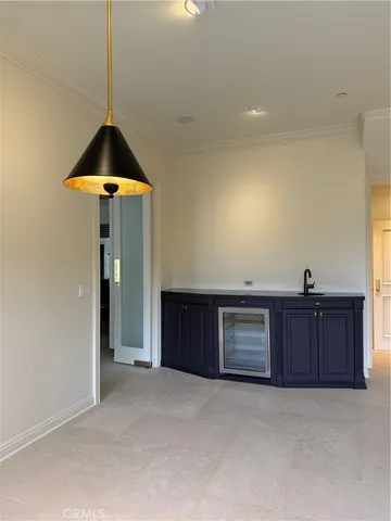 a view of an empty room and a kitchen