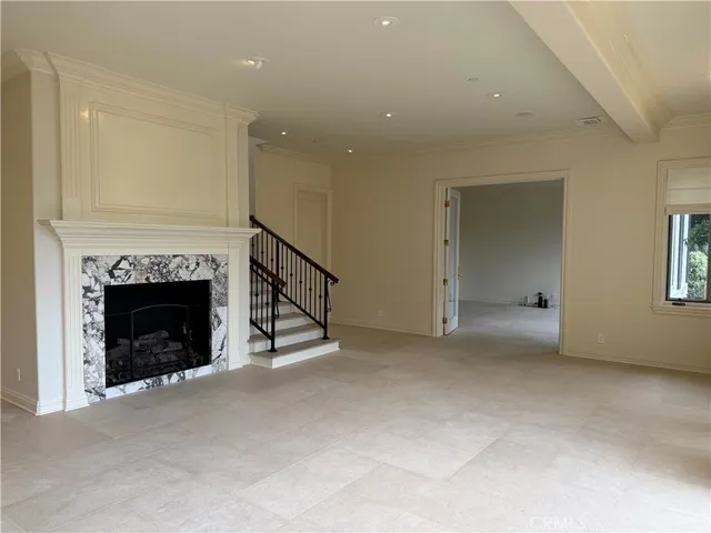 a view of an empty room with a fireplace