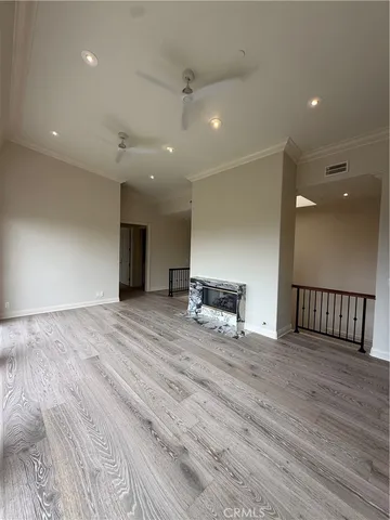 a view of an empty room with a kitchen