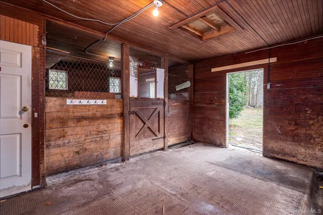 a view of empty room with wooden walls