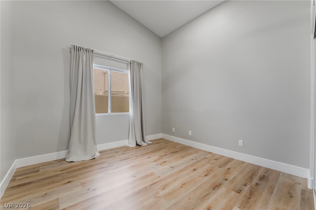 9171 West Viking Road Las Vegas, NV 89147 - Photo 28 of 43 Natural wood-look flooring and ample wall space create a versatile blank canvas.