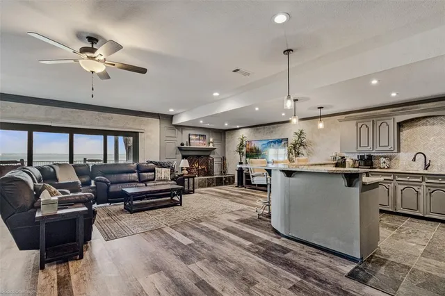 a living room with kitchen island furniture and a chandelier