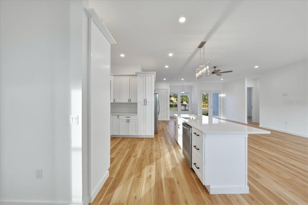 1215 Rio De Janeiro Avenue Punta Gorda, FL 33983 - Photo 29 of 65 a large kitchen with kitchen island a sink stainless steel appliances and white cabinets