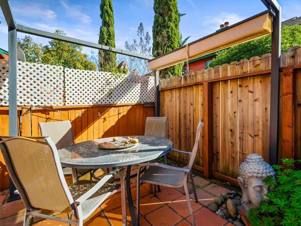 a outdoor seating area with a table and chairs