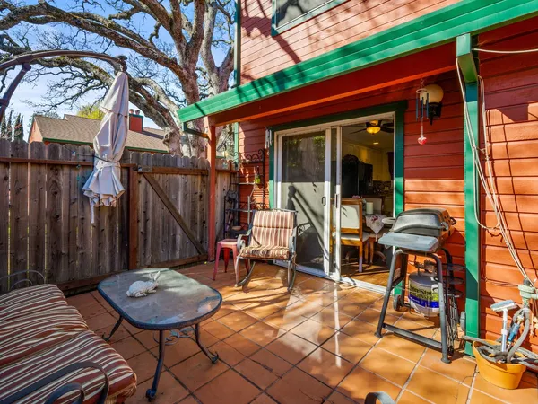 a view of a patio with a table and chairs