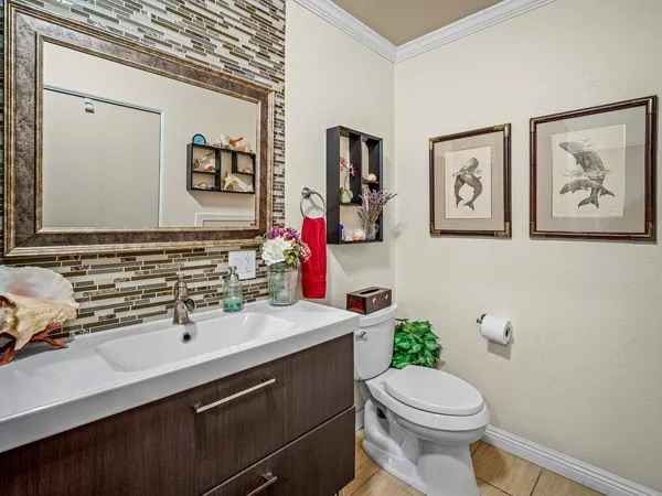 a bathroom with a sink mirror vanity and toilet