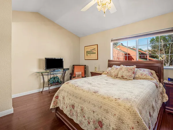 a bedroom with a bed and a flat screen tv