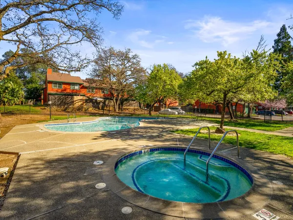 a view of a swimming pool with a yard