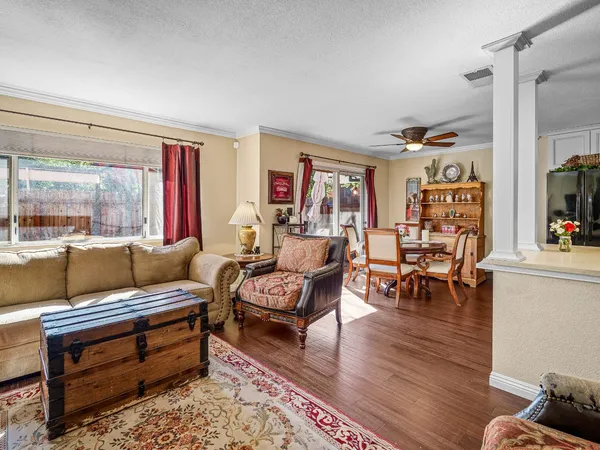 a living room with furniture and a wooden floor