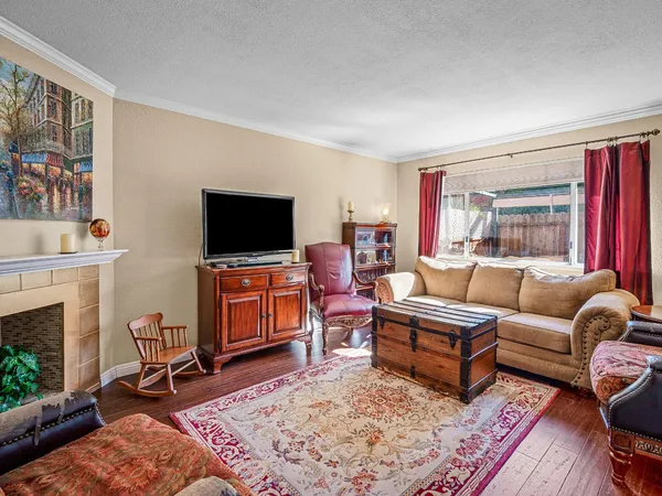 a living room with furniture a rug and a flat screen tv