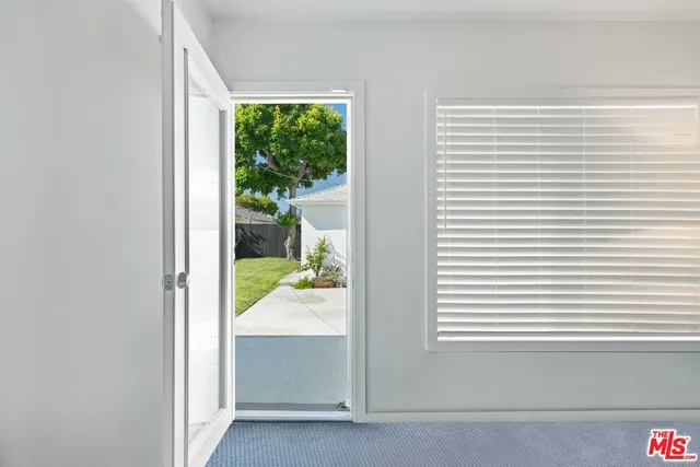 a view of a house with backyard and a tree