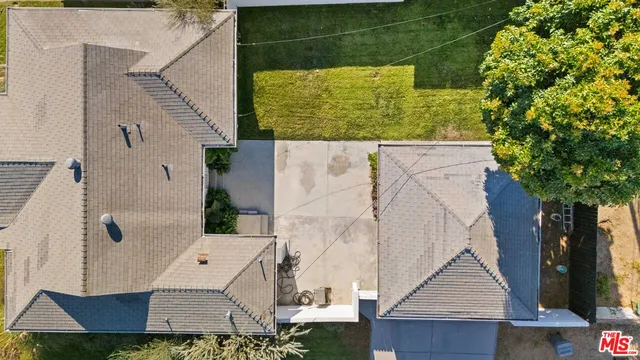 an aerial view of multiple house with yard