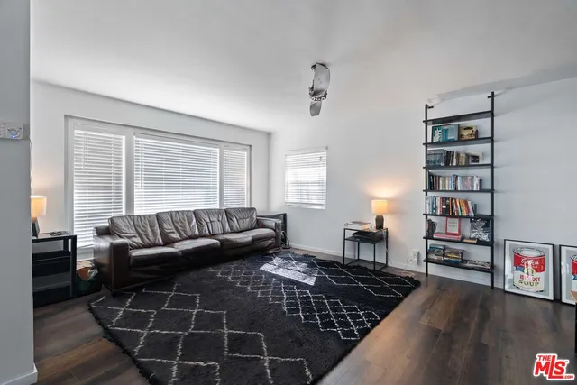 a living room with furniture and a book shelf