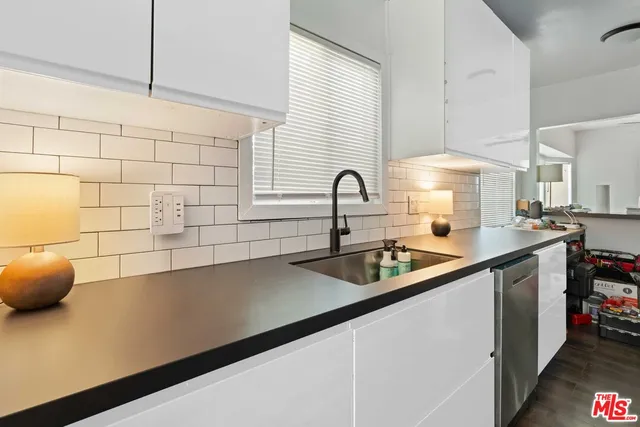 a kitchen with stainless steel appliances a sink and a stove