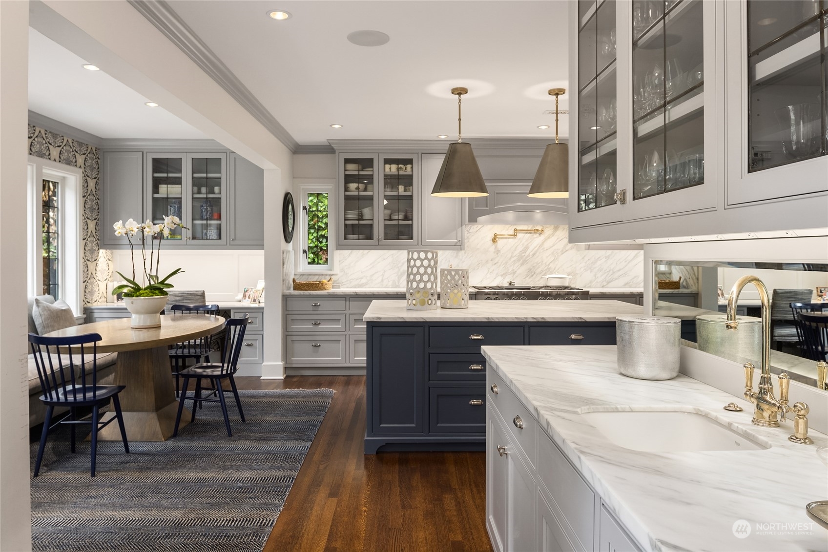 2045 Parkside Drive East Seattle, WA 98112 - Photo 15 of 38 a kitchen with stainless steel appliances kitchen island granite countertop a table chairs and a wooden cabinets