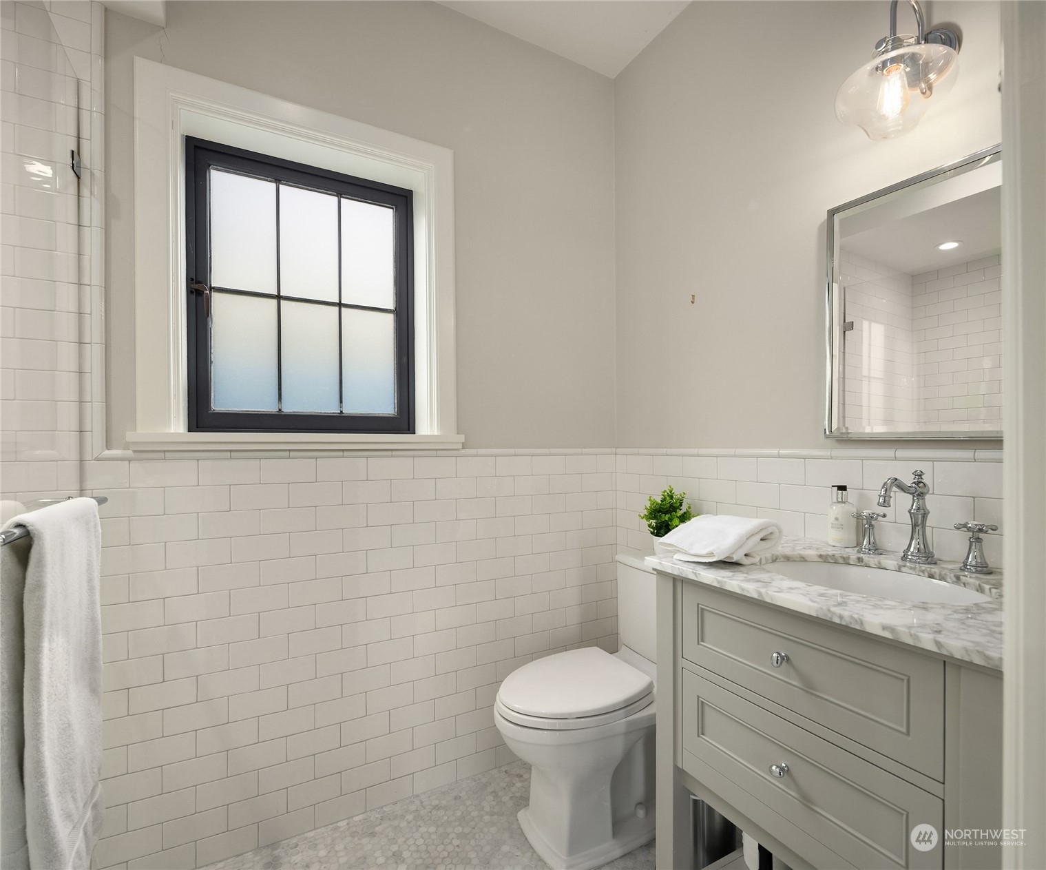 2045 Parkside Drive East Seattle, WA 98112 - Photo 24 of 38 a bathroom with a granite countertop toilet a sink and mirror