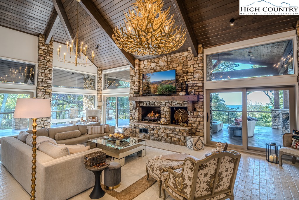804 Crest Trail Linville, NC 28646 - Photo 11 of 40 a living room with fireplace furniture and a large window