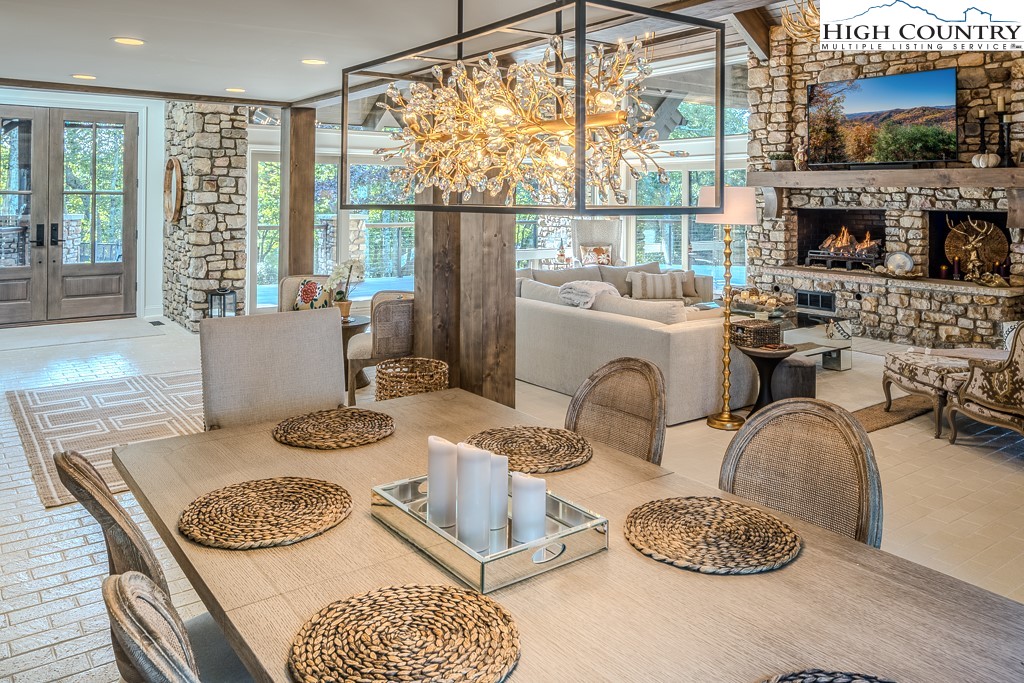 804 Crest Trail Linville, NC 28646 - Photo 13 of 40 a living room with fireplace furniture and a floor to ceiling window
