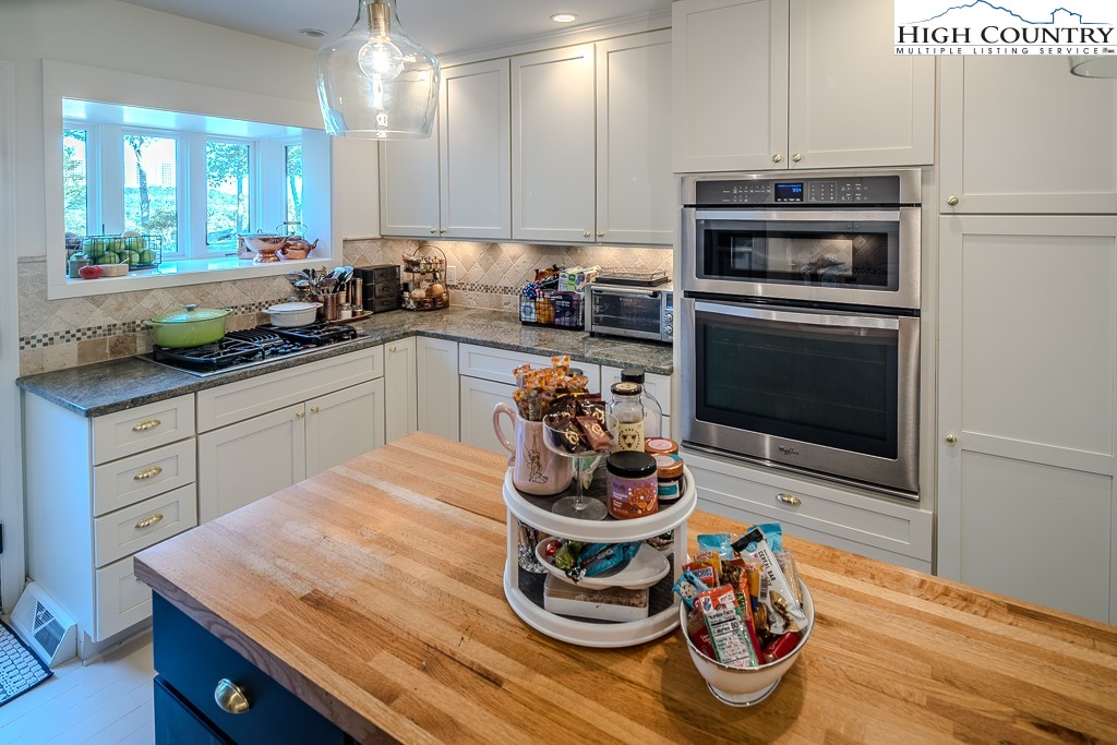 804 Crest Trail Linville, NC 28646 - Photo 15 of 40 a kitchen with stainless steel appliances a stove a sink and a microwave