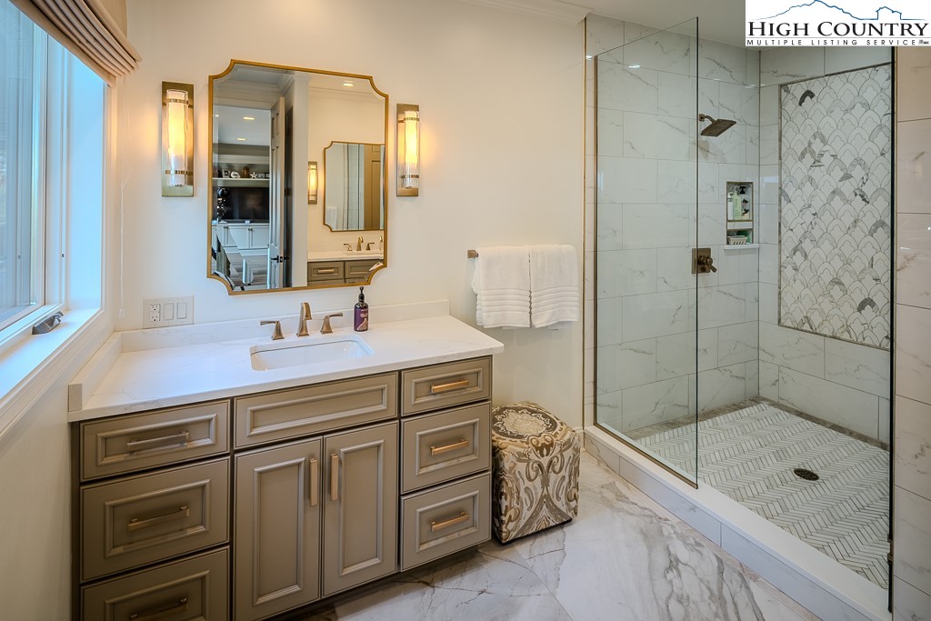 804 Crest Trail Linville, NC 28646 - Photo 18 of 40 a bathroom with a shower sink and mirror