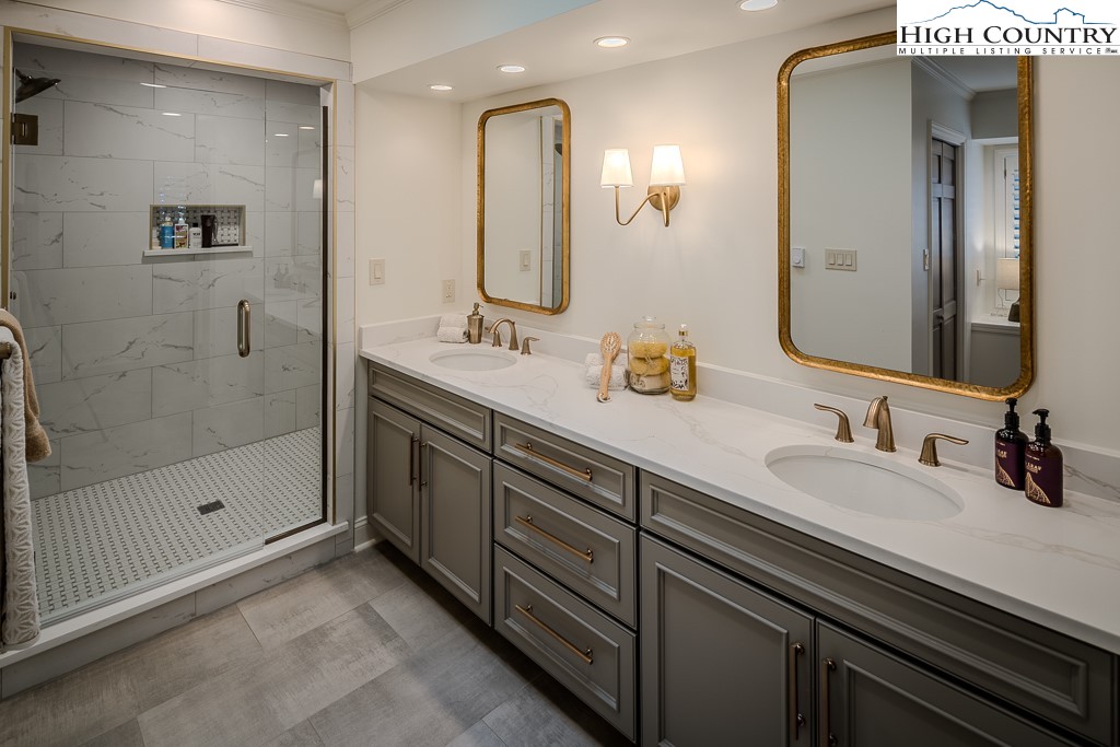 804 Crest Trail Linville, NC 28646 - Photo 28 of 40 a bathroom with a double vanity sink mirror and shower