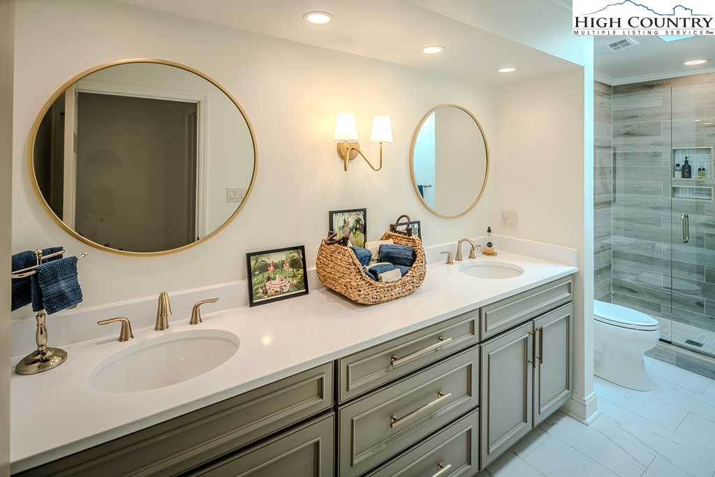 804 Crest Trail Linville, NC 28646 - Photo 30 of 40 a bathroom with a double vanity sink and a mirror