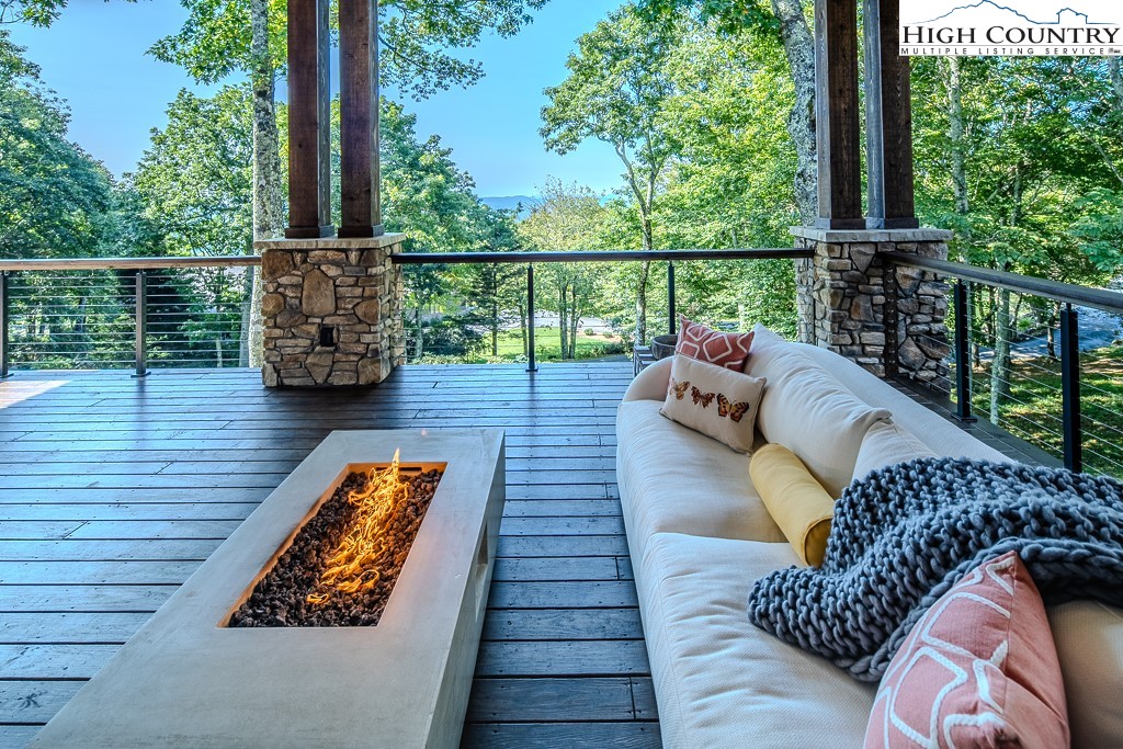 804 Crest Trail Linville, NC 28646 - Photo 33 of 40 a balcony with wooden floor table and chairs
