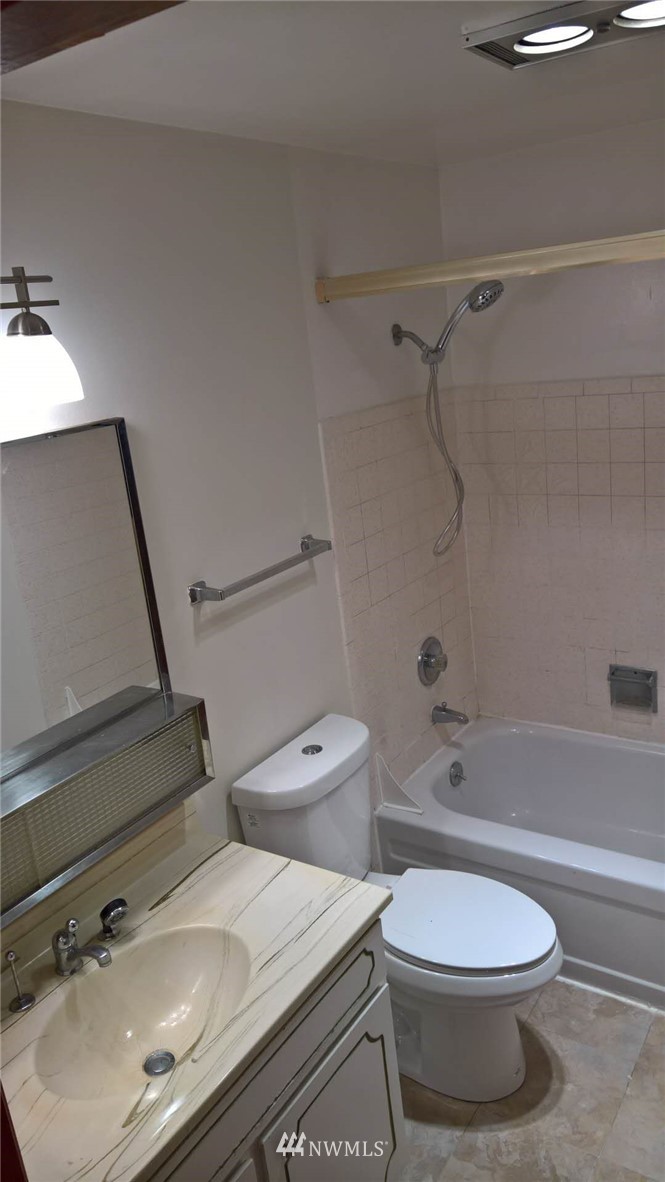 4215 Whitman Avenue North Seattle, WA 98103 - Photo 11 of 16 a bathroom with a sink a toilet and shower