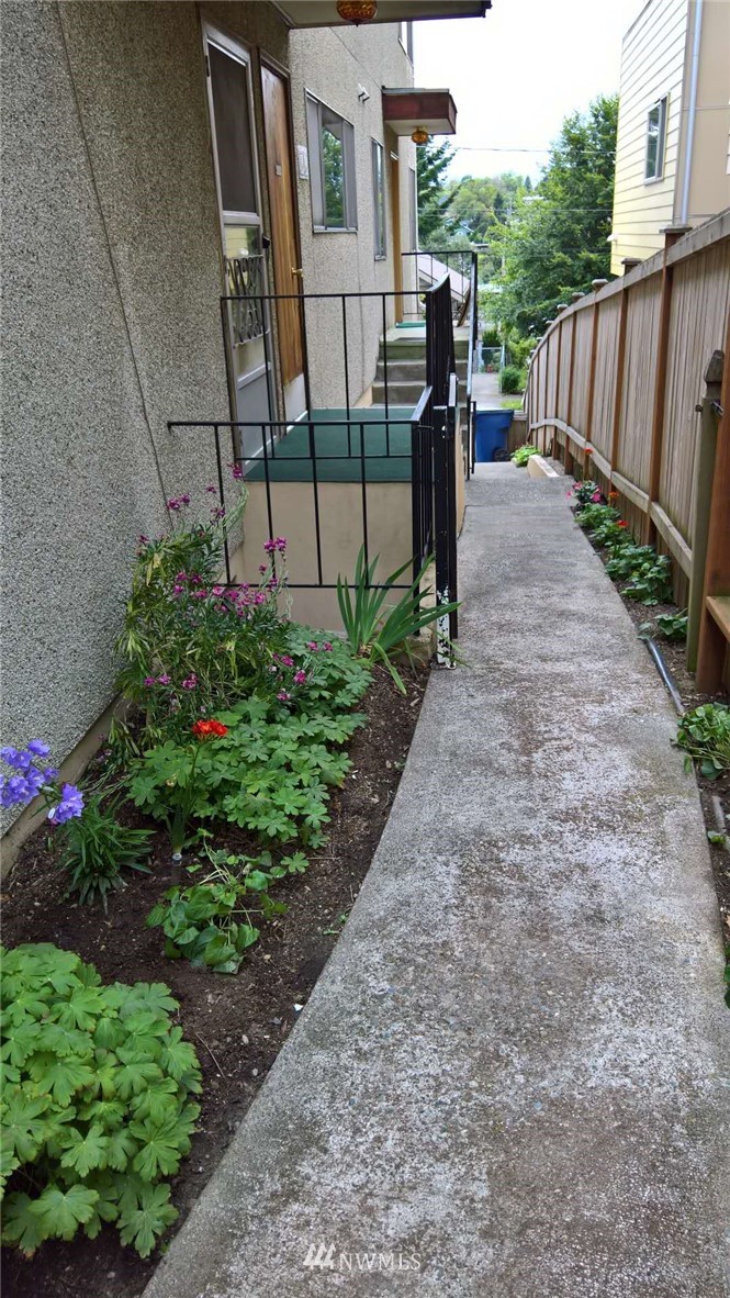 4215 Whitman Avenue North Seattle, WA 98103 - Photo 13 of 16 a view of a pathway of a house with wooden fence