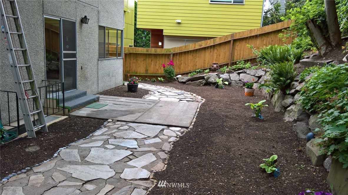 4215 Whitman Avenue North Seattle, WA 98103 - Photo 14 of 16 a view of a backyard with plants and trees