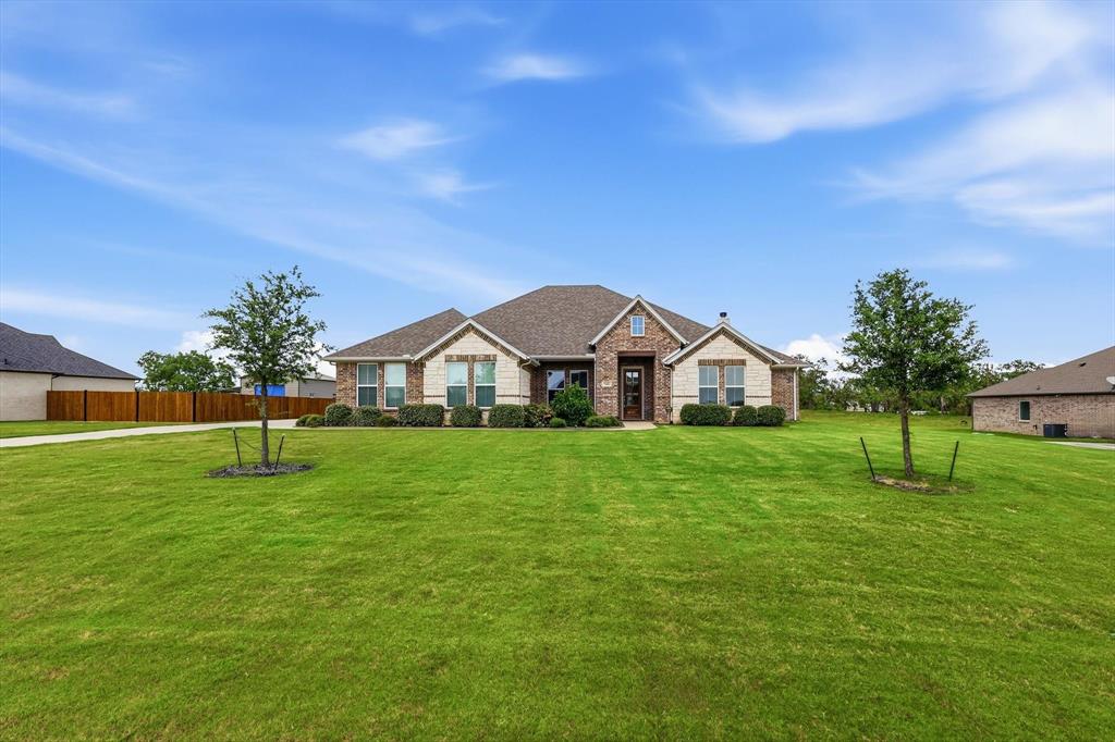 a front view of a house with a yard