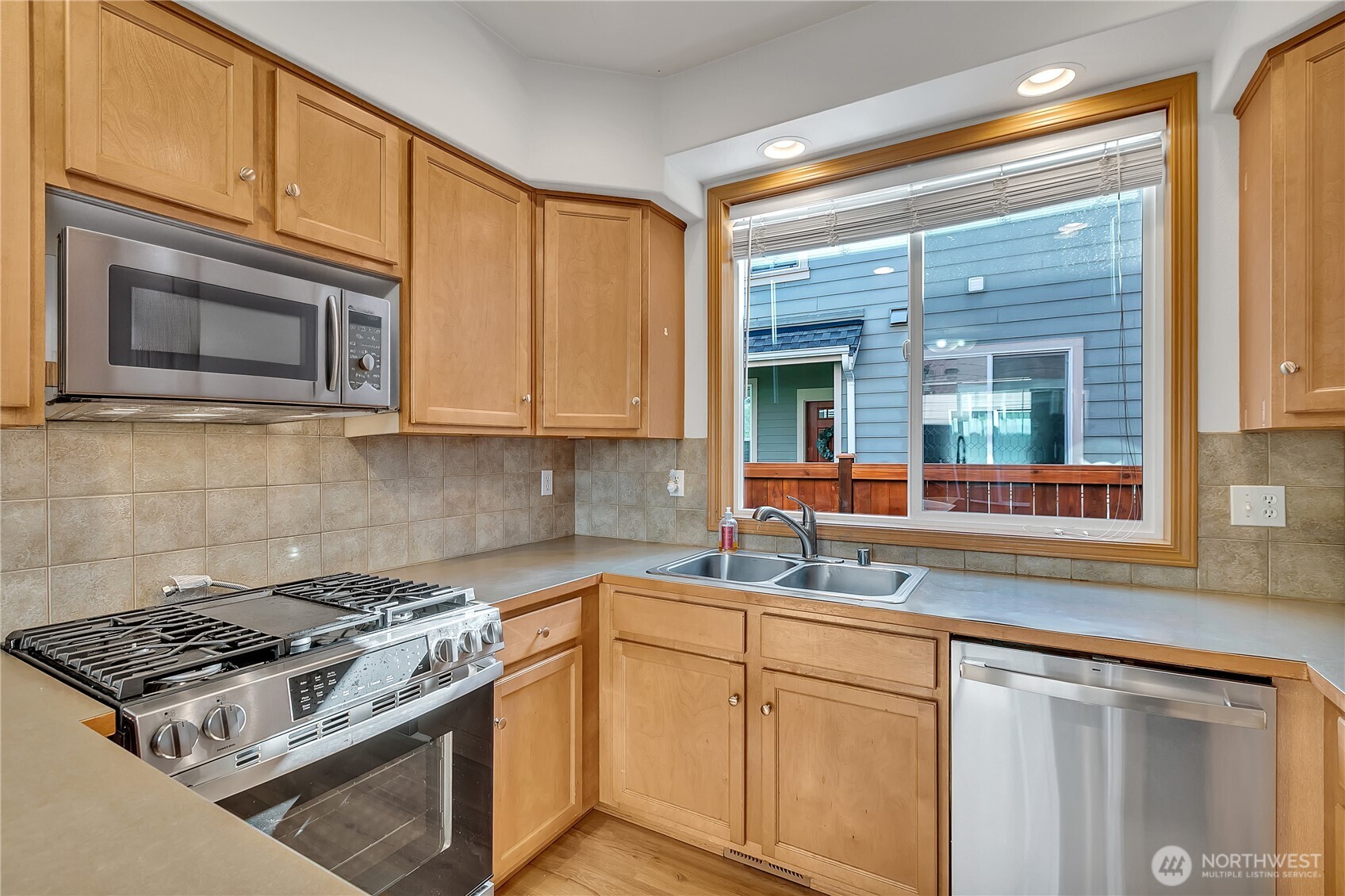 1720 Garfield Street, Unit 4 Enumclaw, WA 98022 - Photo 15 of 38 a kitchen with stainless steel appliances granite countertop white cabinets and a stove top oven